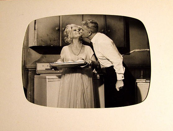 An affectionate Oliver smooches Lisa